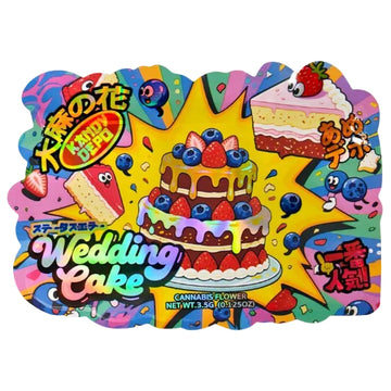 Colorful illustrated product packaging for a Japanese candy product labeled 'Wedding Cake' with 'Cannabis Flower' text, featuring a decorated cake, strawberries, blueberries, cake slices, and playful cartoon graphics on a bright yellow starburst background.