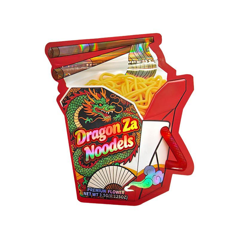 A novelty snack package shaped like a red ramen cup, labeled 'Dragon Za Noodles' with a green dragon illustration, shown open with yellow noodles and chopsticks on a white background.